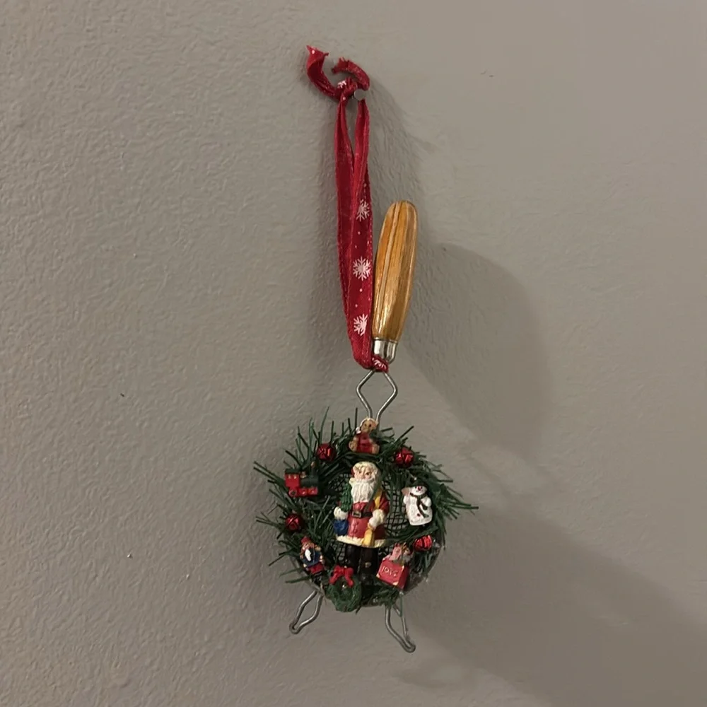 Handmade Santa Holiday Wreath on an old tea strainer.